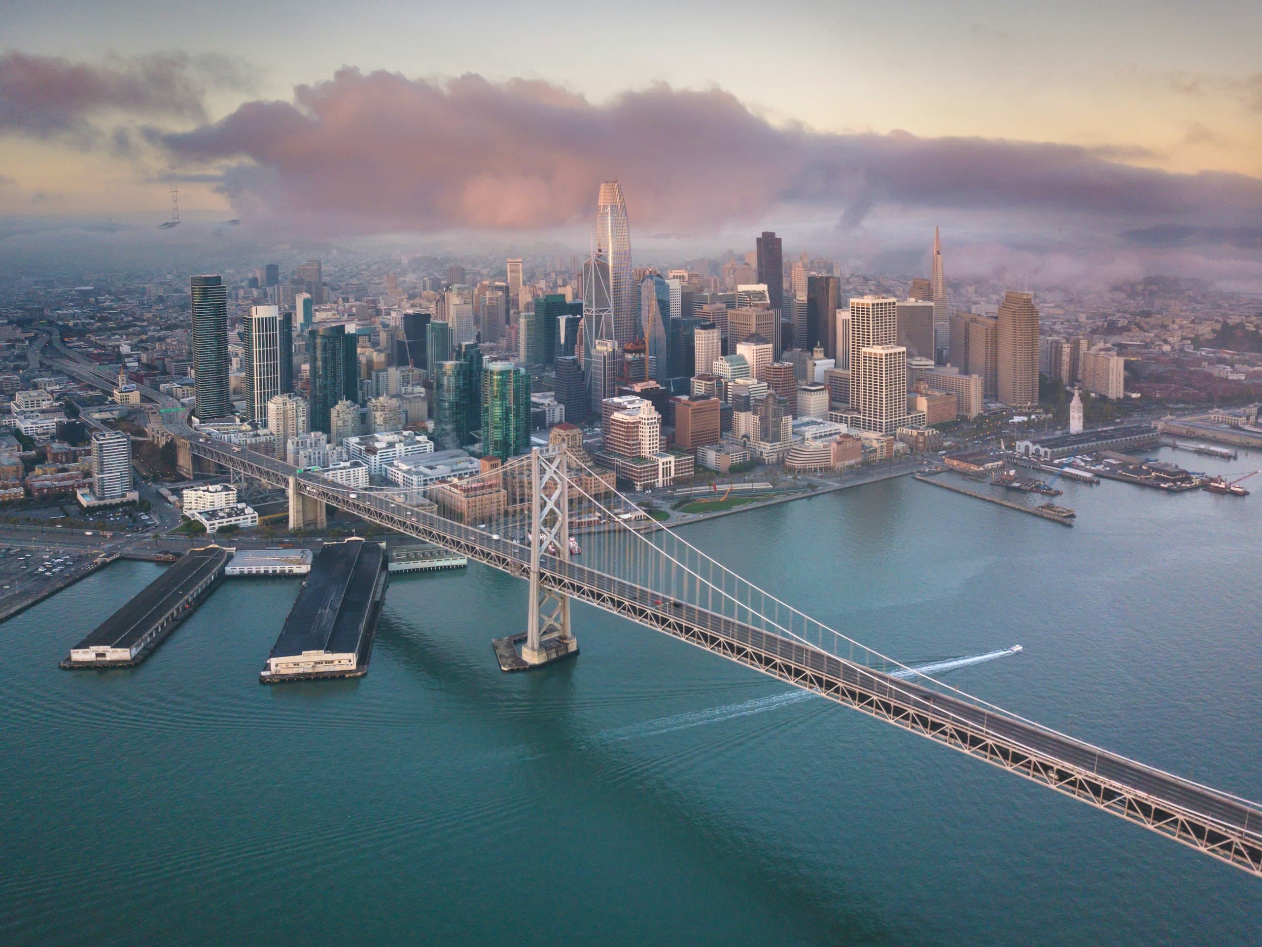Aerial view of downtown San Francisco and the Bay Bridge at sunset