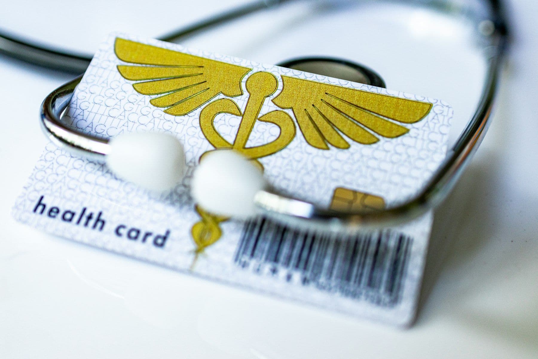 A health insurance card under a stethoscope