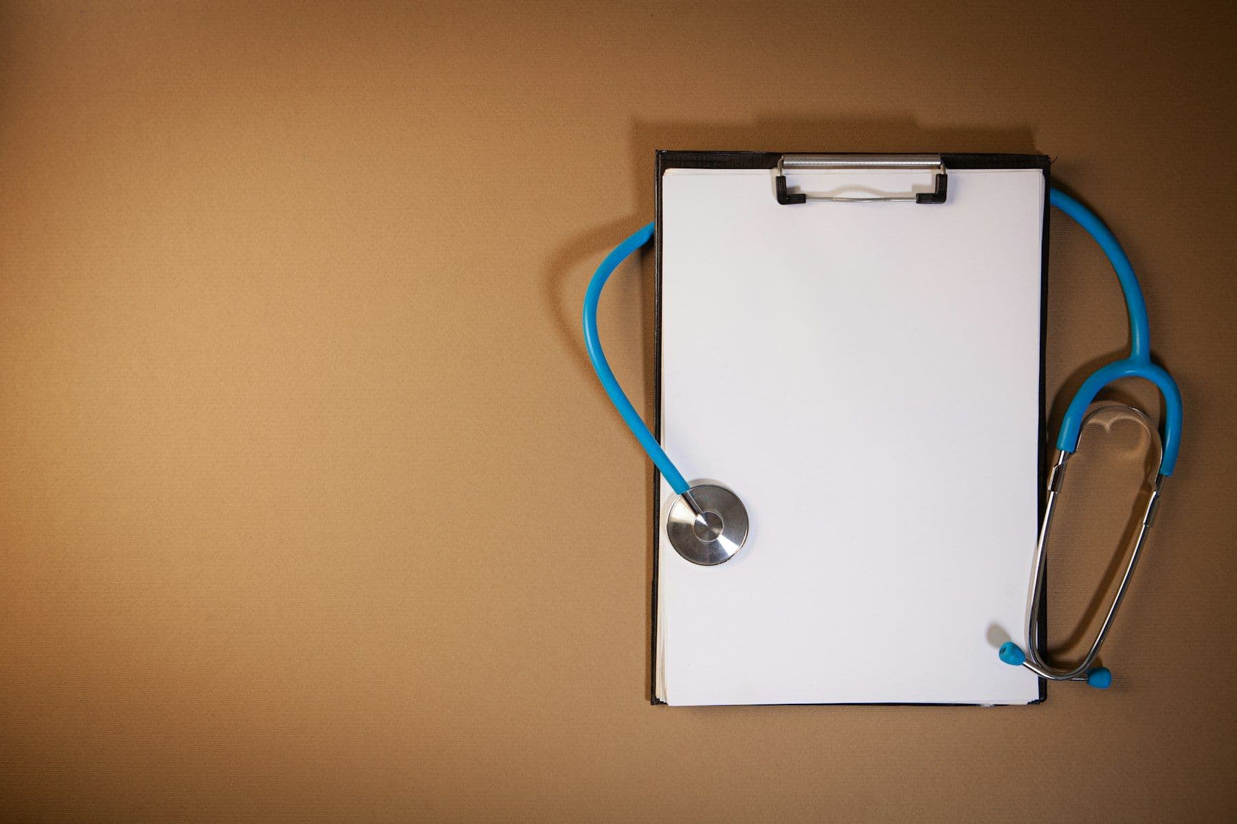 A clipboard with a blank form and a stethoscope